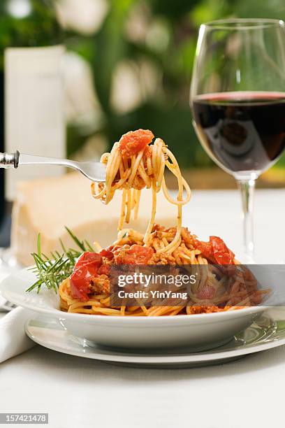 italian pasta spaghetti bolognese dinner with wine and bottle - italian food and wine stock pictures, royalty-free photos & images