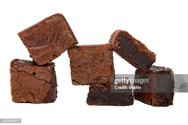 chocolate brownies stacked in front of a white background - brownie stockfoto's en -beelden