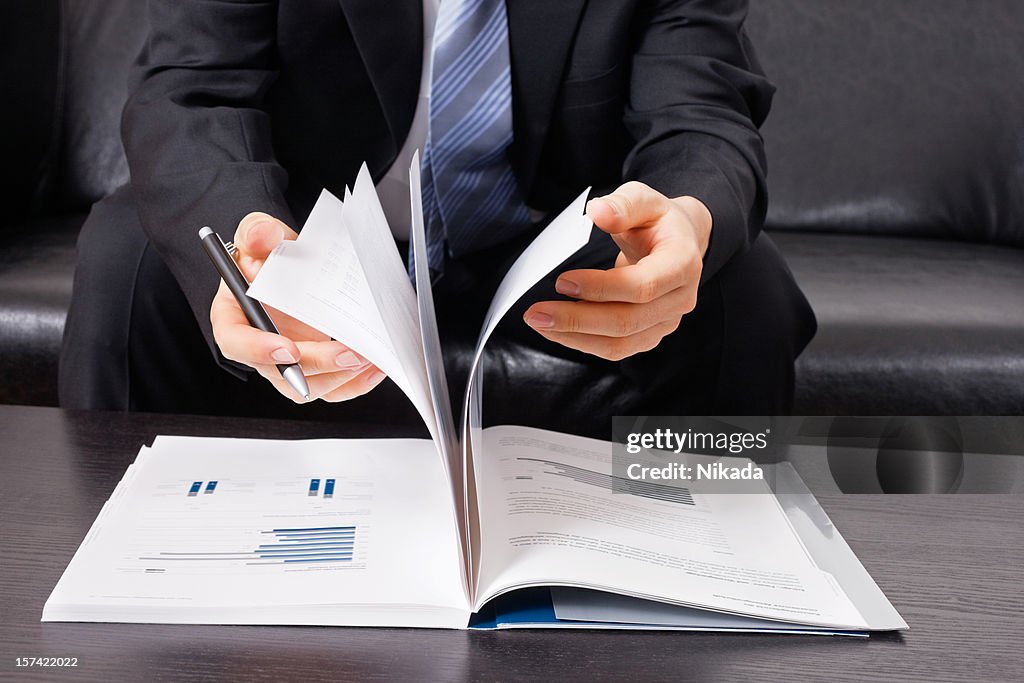 Businessman with business report and pen