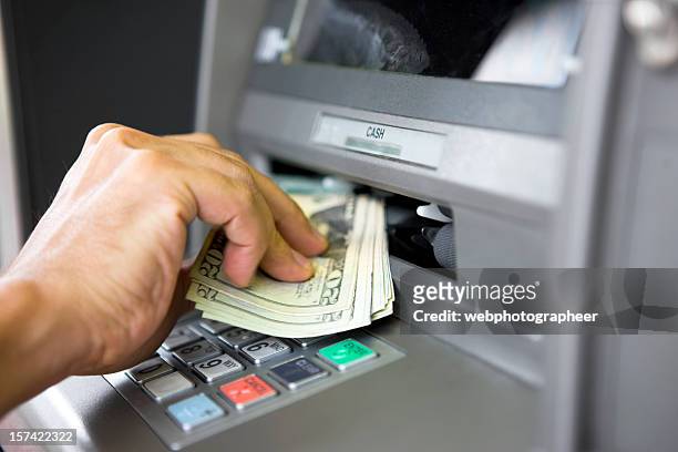 taking money from atm machine - atm cash stock pictures, royalty-free photos & images