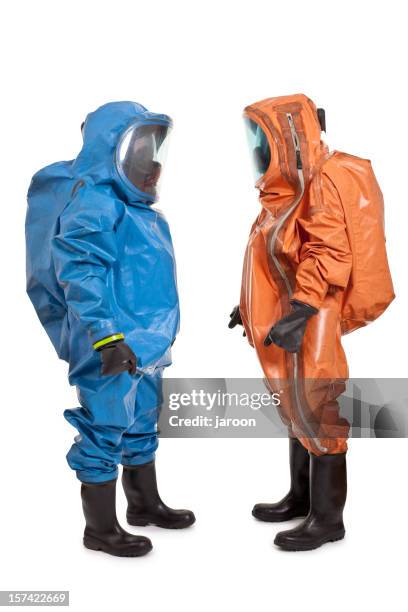 two men wearing chemical protection suit - stralingspak stockfoto's en -beelden