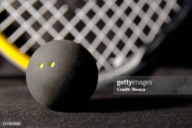 squash ball and racket on black - squash sport stockfoto's en -beelden