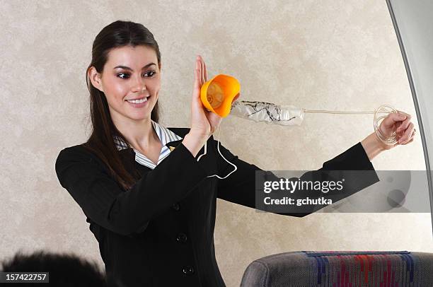 flight attendant and oxygen mask - airhostess stock pictures, royalty-free photos & images