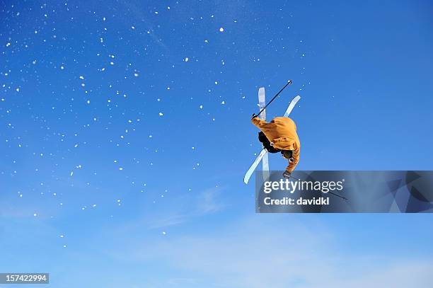 skier iron cross stunt against blue sky - freestyle skiing stock pictures, royalty-free photos & images