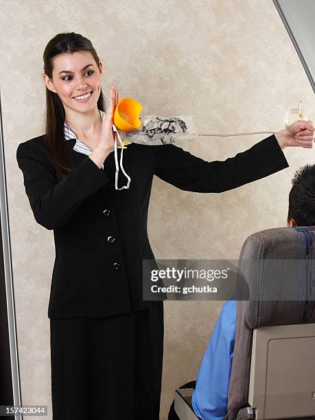 flight attendant demonstrating oxygen mask - oxygen mask stock pictures, royalty-free photos & images