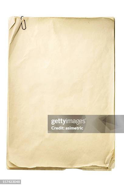 blank crinkly beige paper with paper clip - pile of paper stockfoto's en -beelden