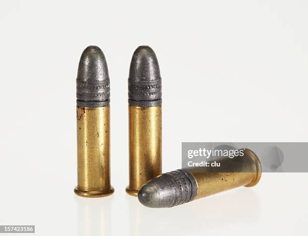 three bullets on white background - kogel stockfoto's en -beelden