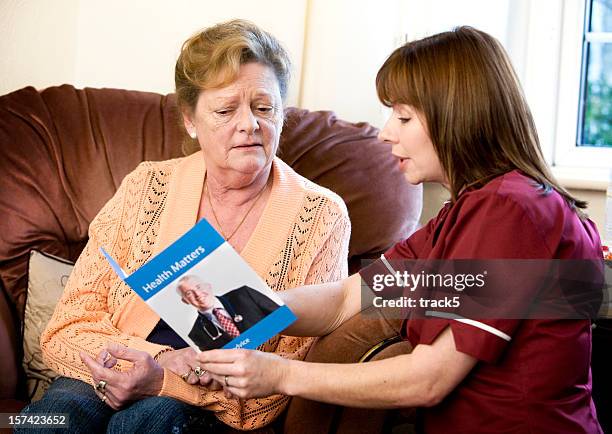 words of advice from a care nurse providing advice - brochure stock pictures, royalty-free photos & images
