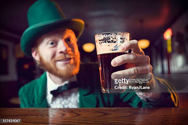 irish character / leprechaun making a toast with beer - st patricks day stock pictures, royalty-free photos & images