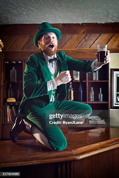 irish / leprechaun character with pint of beer - leprechaun stock pictures, royalty-free photos & images