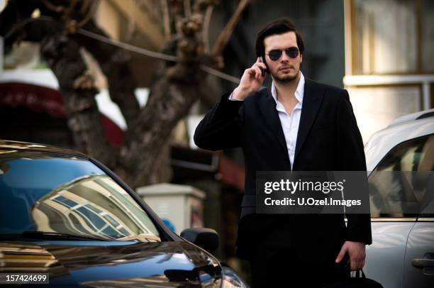 man in black - black suit sunglasses stock pictures, royalty-free photos & images