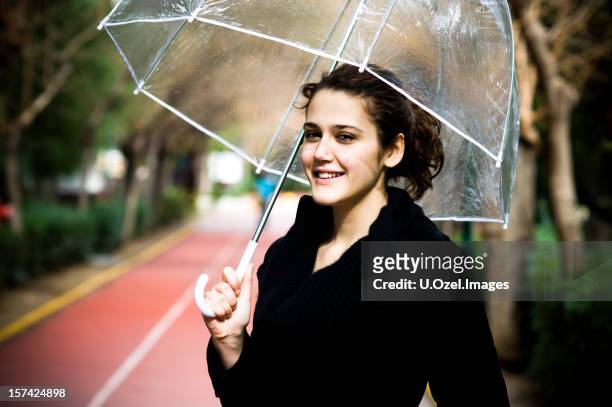 belle femme avec un parapluie - automne femme stock-fotos und bilder