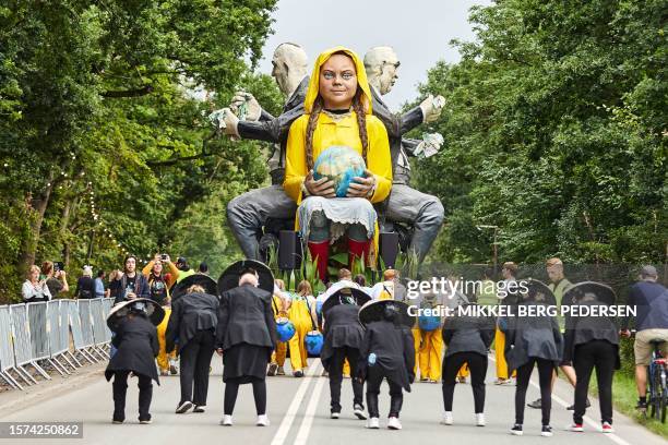Members of the Italian carnival troupe La Compagnia del Carnevale and participants from the VIA University College Aarhus parade around a giant doll...