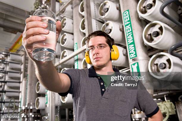 water technician inspects water at public utility plant - aquatic plant stock pictures, royalty-free photos & images