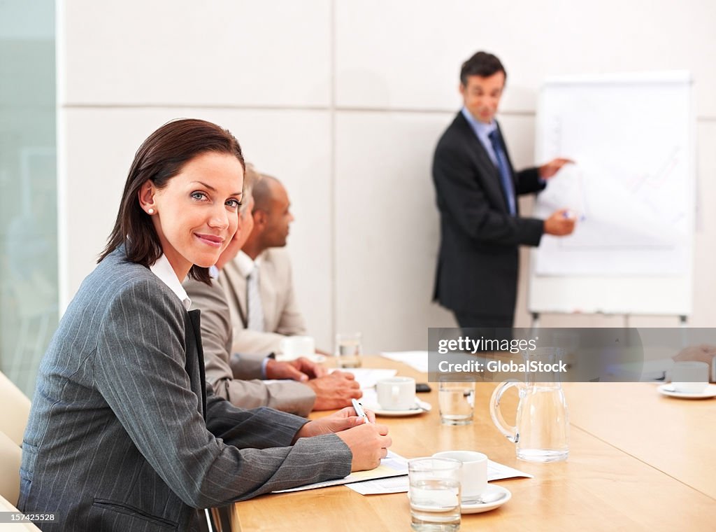 Businesswoman with colleagues in background