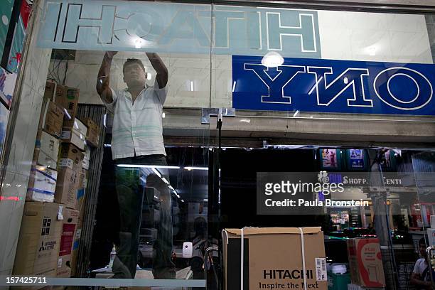 Signs are put up at a new store selling a variety of electrical appliances, on November 30, 2012 in downtown Yangon, Myanmar. Business opportunities...