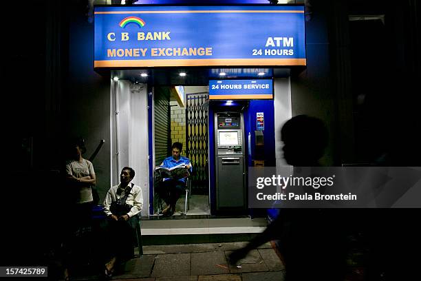 New ATM bank machines stand on a street, simplifying the access to Kyat, the local Burmese currency, on November 30, 2012 in downtown Yangon,...