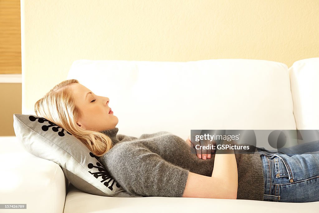 Blond woman sleeping on a couch