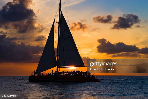 sailboat and sunset - catamaran stock pictures, royalty-free photos & images