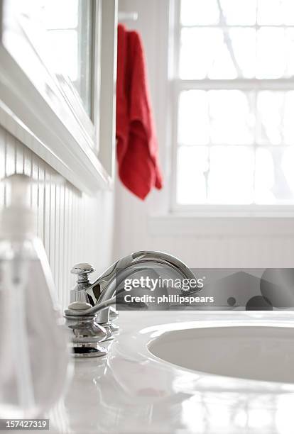 faucet in  white bathroom with a red towel. - bathroom sink stock pictures, royalty-free photos & images