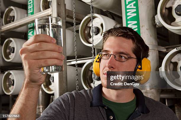 technician in reverse osmosis water purification plant checks quality - reverse osmosis stock pictures, royalty-free photos & images