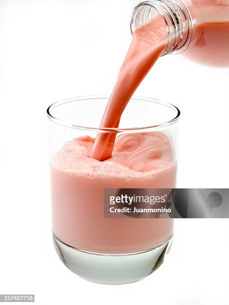 high definition strawberry milkshake (or protein drink) - milk pour white background bildbanksfoton och bilder