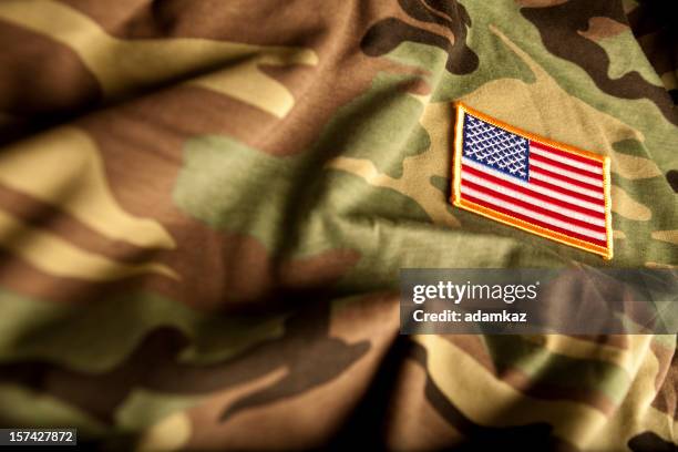 american flag and camoflage (military series) - veterans day stock pictures, royalty-free photos & images