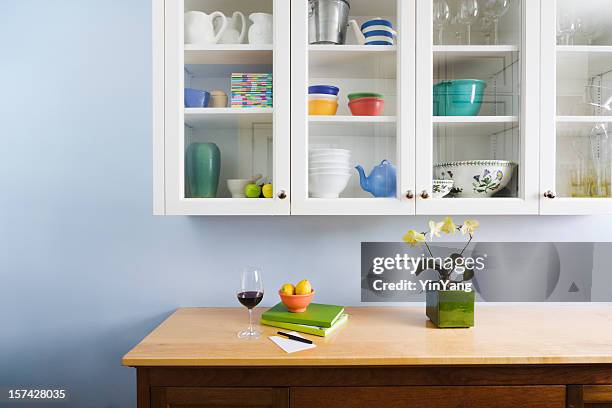 domestic kitchen counter top and cabinet display of neat organization - kitchen cabinet stock pictures, royalty-free photos & images