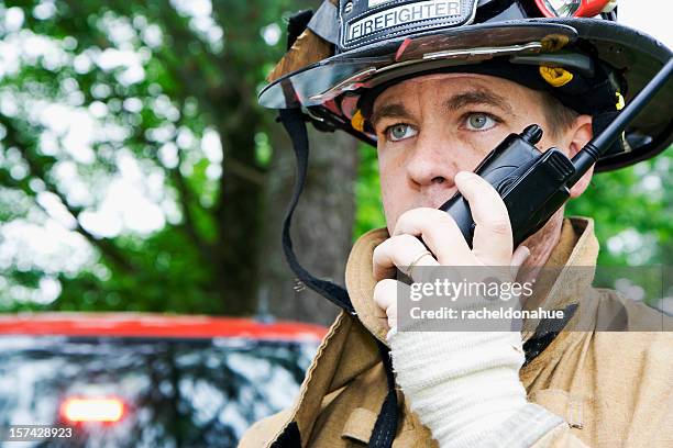 fireman talking on radio - emergency services occupation stock pictures, royalty-free photos & images