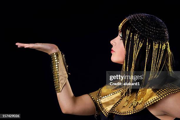 person portraying cleopatra on black background - cleopatra stock pictures, royalty-free photos & images