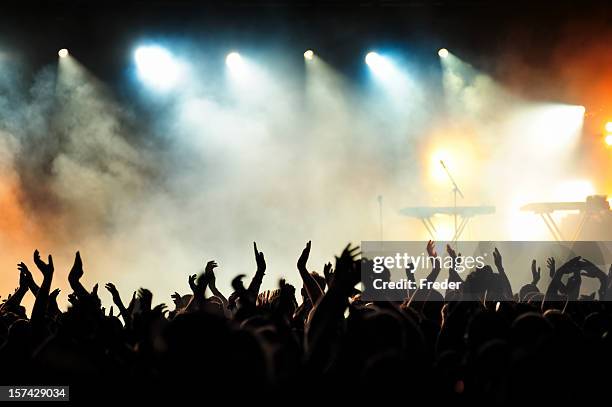 concert crowd cheering and awaiting a band to take the stage - alternative rock stock pictures, royalty-free photos & images