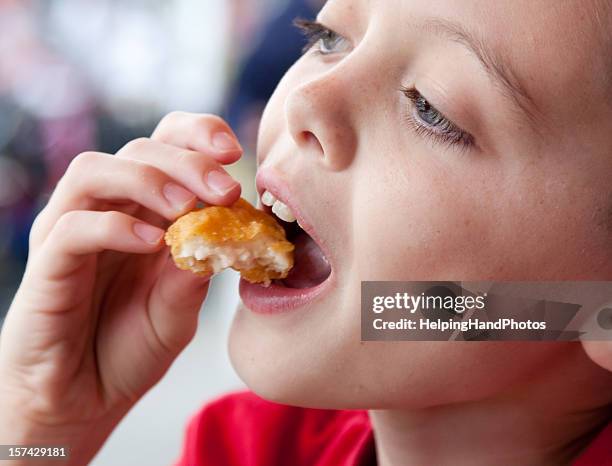 boy eating chicken nugget - deep fried bildbanksfoton och bilder