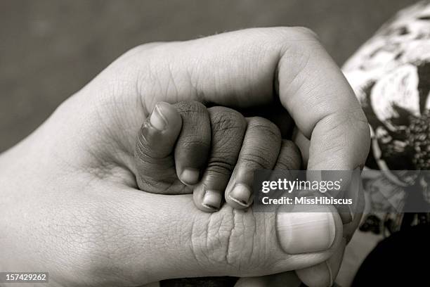 baby orphan hand - black premature babies stock pictures, royalty-free photos & images