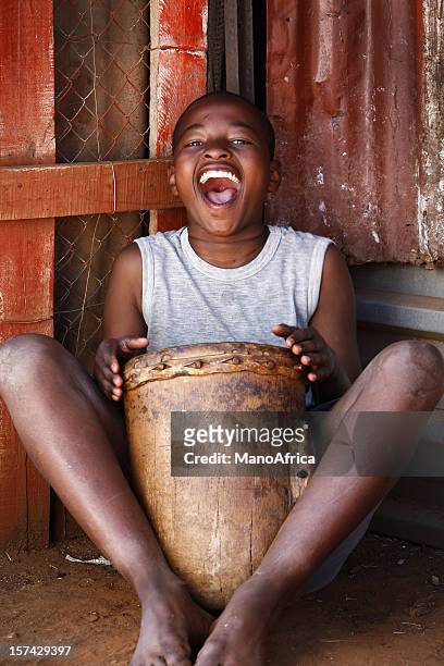 african drummer boy - african drum stock pictures, royalty-free photos & images