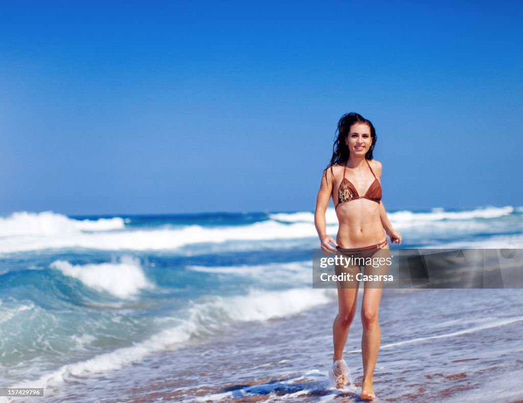 Young woman running on the beach