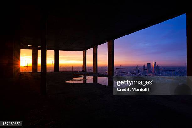 cityscape view from construction site at sunset - work sites night stock pictures, royalty-free photos & images