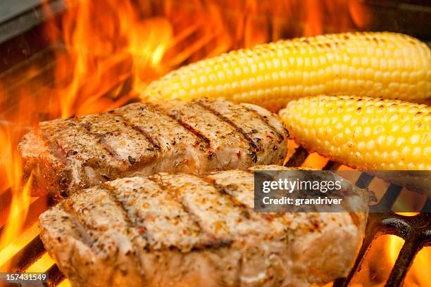 grilled pork chops and corn in flames - pork chop stock pictures, royalty-free photos & images