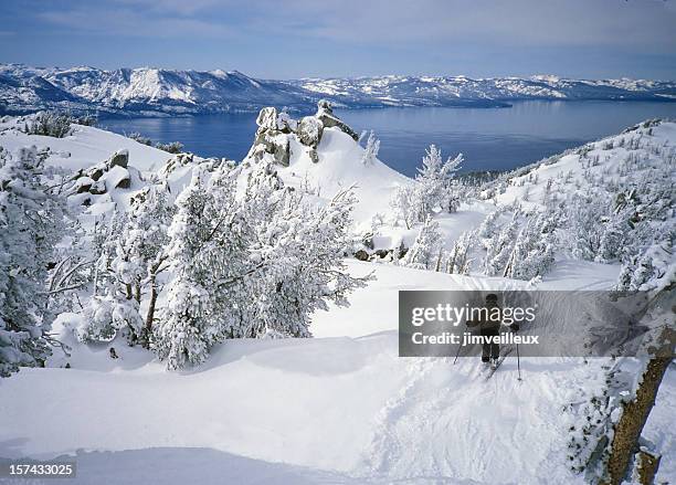 skier in fresh snow above alpine lake tahoe - lake tahoe skiing stock pictures, royalty-free photos & images