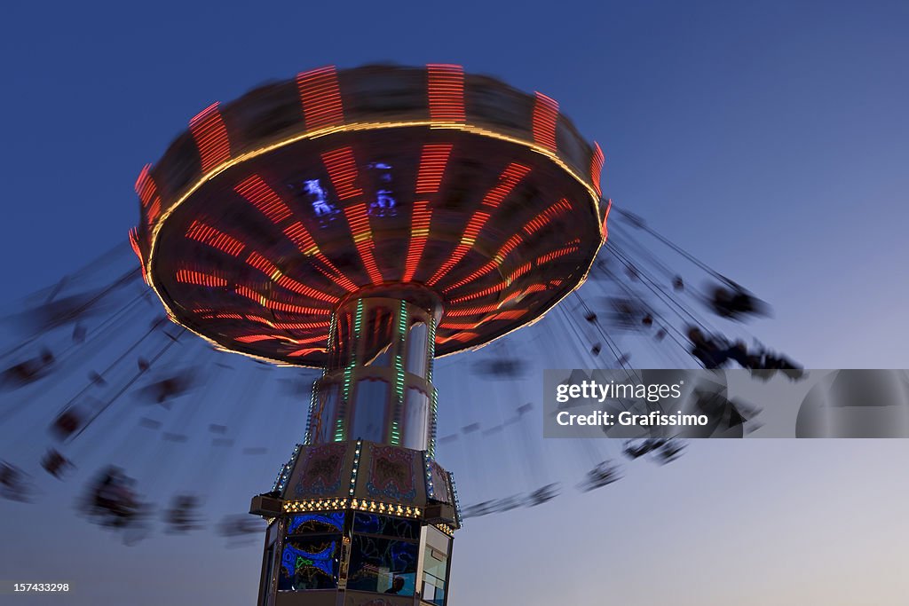 Blurred motion of merry-go-round chairoplane at night