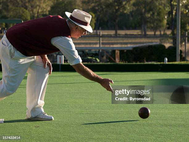 man lawn bowling on sunny day - lawn bowling stock pictures, royalty-free photos & images