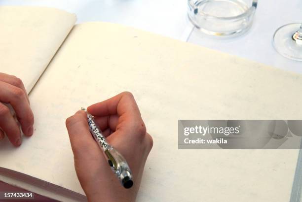 writing in a empty book with copyspace - gastenboek stockfoto's en -beelden