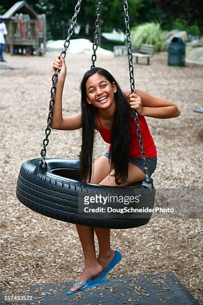 laughing girl on tire swing - 13 year old girls in shorts stock pictures, royalty-free photos & images