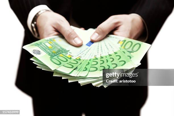 man holding money - one hundred euro note stock pictures, royalty-free photos & images