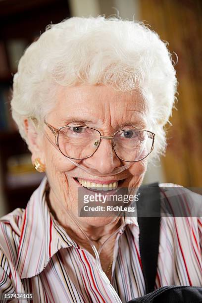 senior citizen woman with oxygen tube - nasal cannula stock pictures, royalty-free photos & images