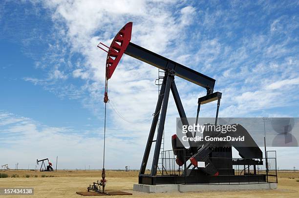 oil pumpjack with clouds in background - lost hills california stock pictures, royalty-free photos & images
