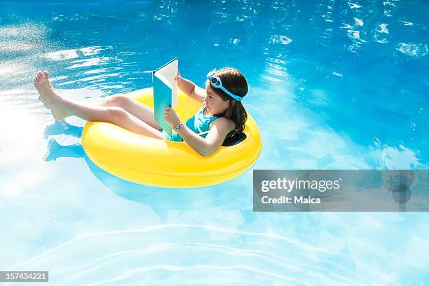 children reading on a lifesaver - school holiday stock pictures, royalty-free photos & images