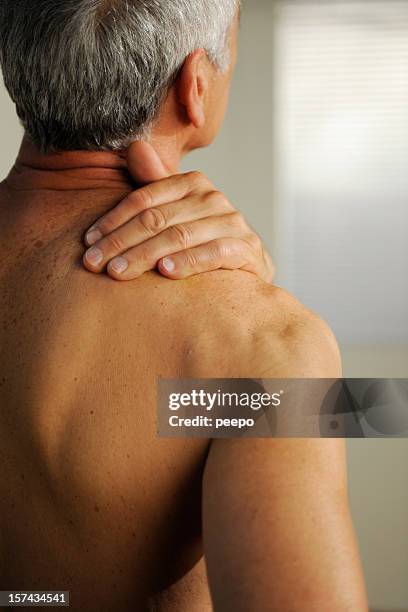 senior with neck pain - over shoulder man stockfoto's en -beelden