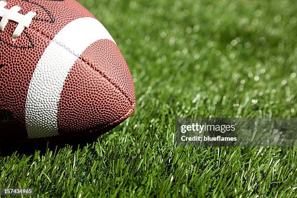 football on turf - football ball close up stock pictures, royalty-free photos & images