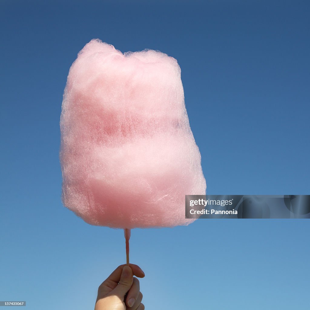Cute, pink, sweet cotton candy above the sky 