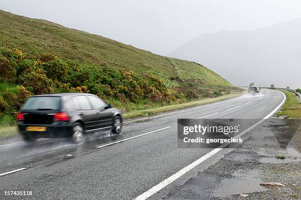 wet rural drive - uk road stock pictures, royalty-free photos & images